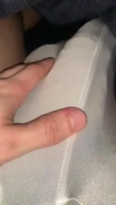 Tugging a strip of white fabric tight, GrowingMuscleBro pulls and yanks it between his fingers