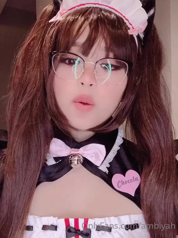 Moaning and licking her lips, Mae shows off her maid outfit, glasses and cat ears