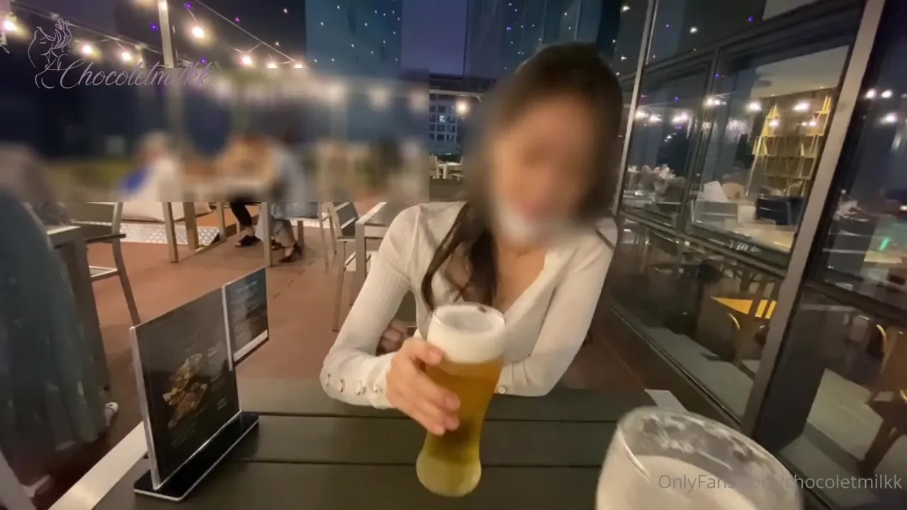 Chocoletmilkk sips beer outside while a man's hand creeps up her bare thigh