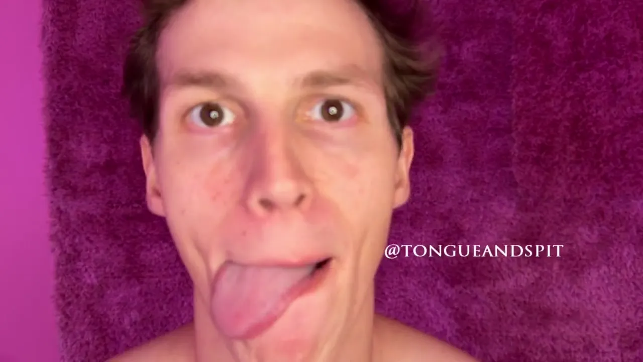 On a pink shag rug, Irina Rivas flaunts her lion tattoo and sticks her tongue out for the camera
