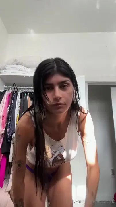 Mia Khalifa in a tee and purple panties, damp hair dripping down her neck