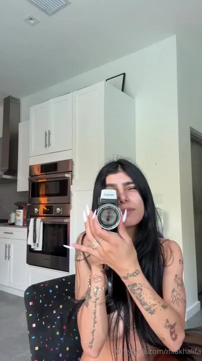 Mia Khalifa strips bare in her kitchen, legs spread wide on a chair, shameless as ever