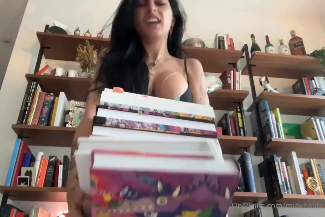 Mia Khalifa slips into a thong and bra, sighing with a sly grin as she pulls on jeans