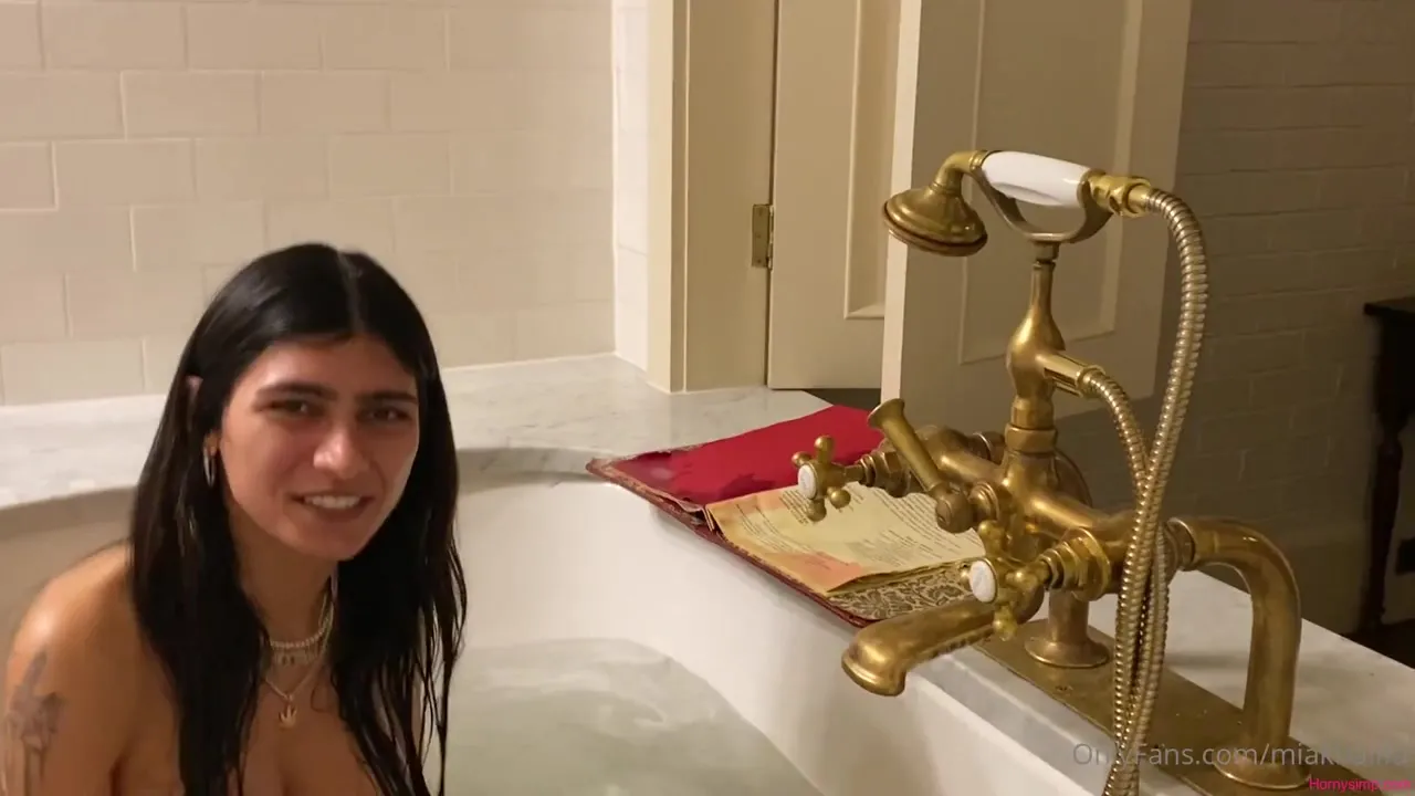 In a bubble-filled marble tub, Mia Khalifa soaks and reads