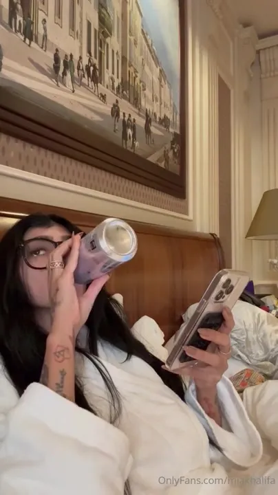 Mia Khalifa shudders with a grin as she strips her robe off topless