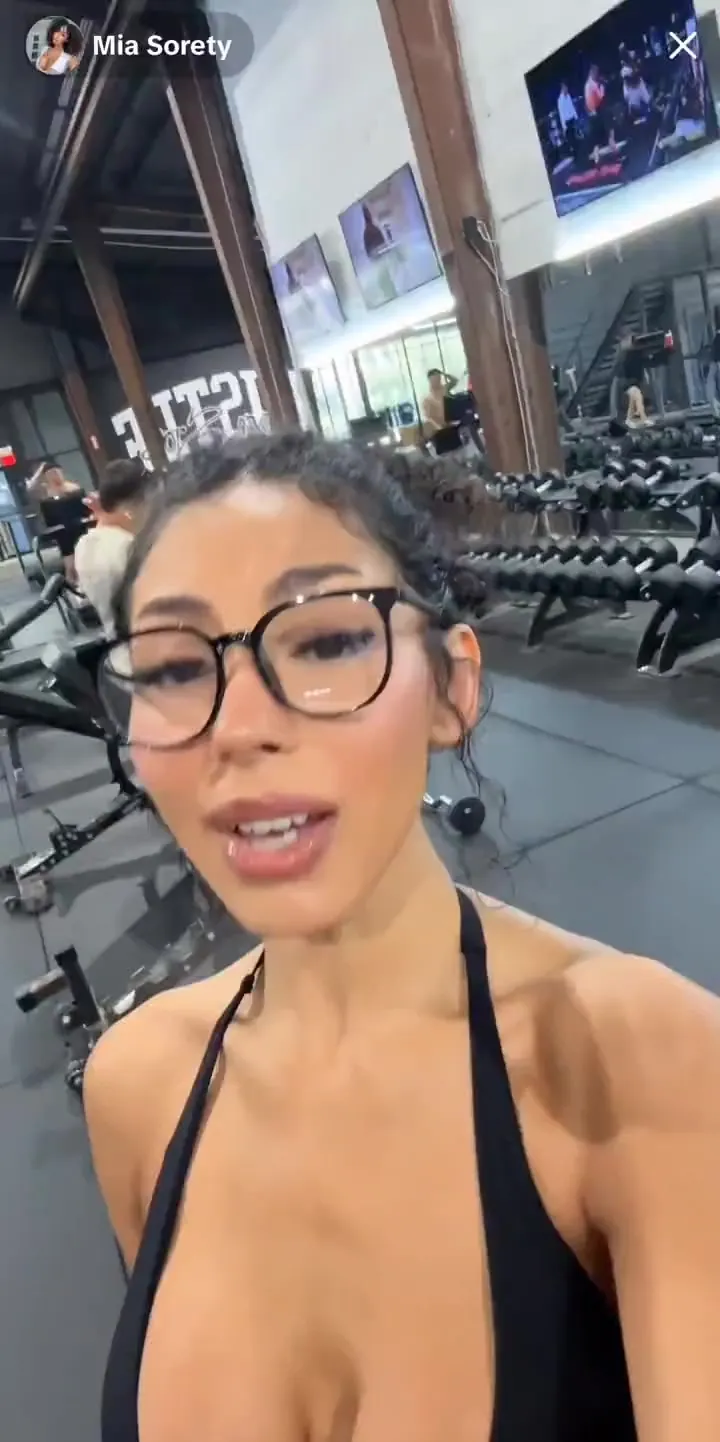 Gym floor and mirror, Mia Sorety sweats through a brutal workout in a red halter