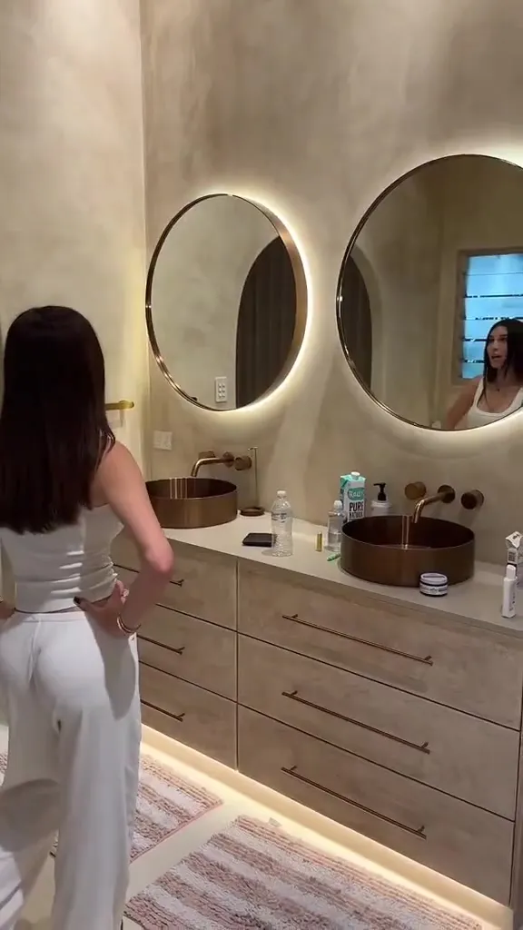By the pool in white loungewear, Mikaela Testa pads barefoot and settles into a teasing mood