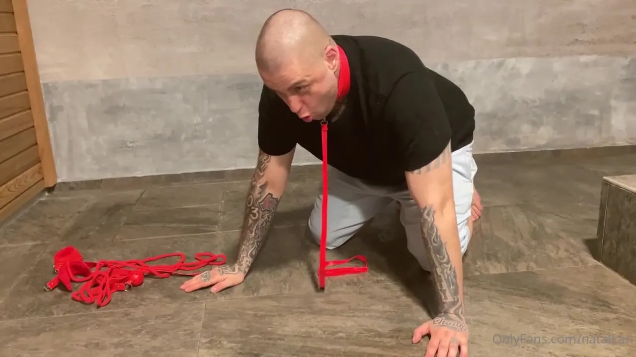 Dragging her tongue over the wet tiles, Zdarma Odber binds a bald, tattooed man in red rope