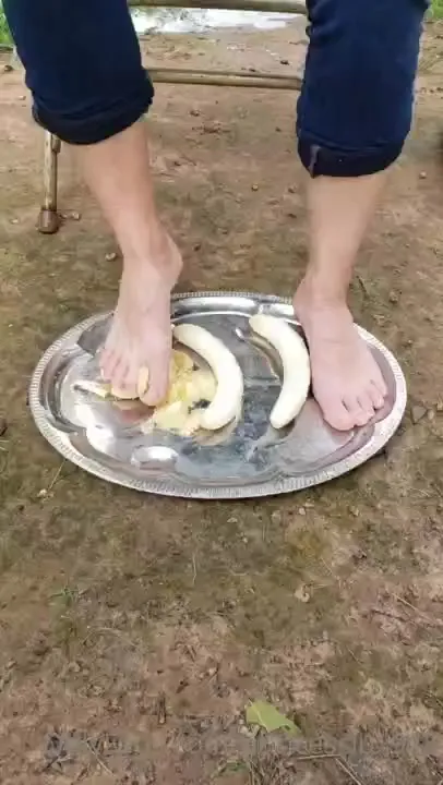 Rolled-up jeans and bare feet, Princess Lux mashes bananas and foam underfoot
