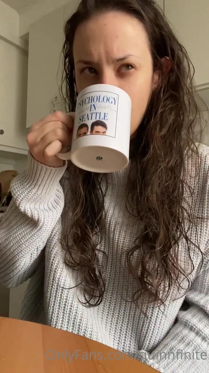 Sipping coffee and flashing a wicked smirk, Quinn Finite lets her wet curls spill everywhere