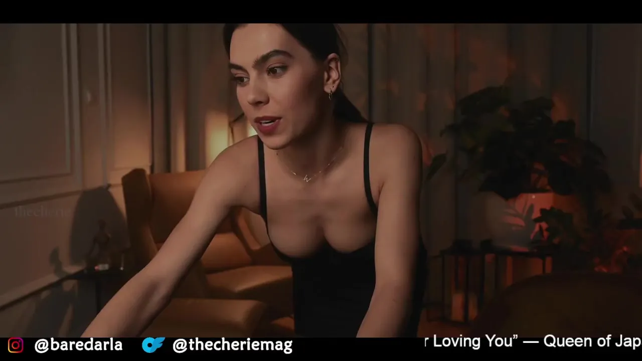 Peeling her black lace straps down, Thecheriemag sinks into a chair and lets her tits spill out
