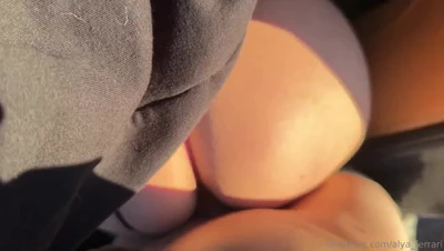 Spreading her ass wide in the back seat, Alya Ferrari guides a cock between her cheeks