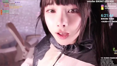 AsianBunnyx squeezes her hands around the inflatable cow suit