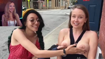 Bebahan in a white corset, grinning through a feed of flashing tits and bare asses, no mercy asked