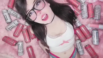 Belledelphine sprawls on pink fluff, Monster cans everywhere, moaning loud for more