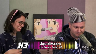 Belle Delphine in cat ears and a hoodie, laughing and flirting at a Halloween-lit set