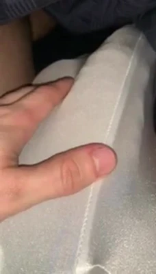 Tugging a strip of white fabric tight, GrowingMuscleBro pulls and yanks it between his fingers