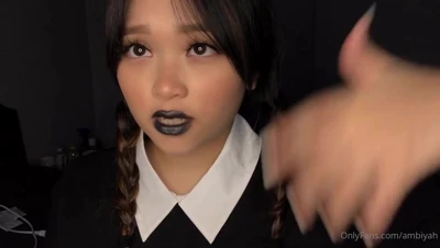 Mae in black lipstick and twin braids, playing the naughty schoolgirl for you