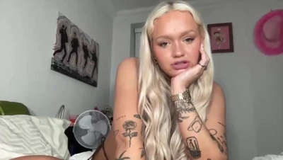 Blonde tattooed Cherryygum in a bedroom closet of hats, squeezing her big natural tits, hungry and nasty