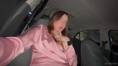Lounging in a pink satin dress, Geraldin Leal works her bare pussy behind the wheel