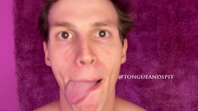 On a pink shag rug, Irina Rivas flaunts her lion tattoo and sticks her tongue out for the camera