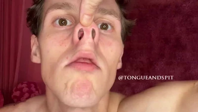 Shirtless and grinning as Irina Rivas squashes his nose flat with one finger