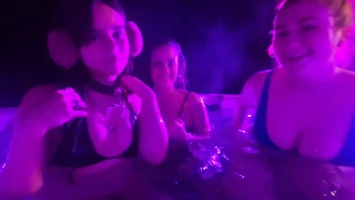 Isla Moon gasping in a steamy hot tub, a friend splashing on each side
