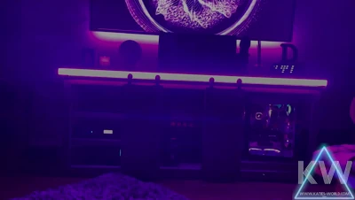Late night in the dark, KatiesWorld sprawls on the purple rug, glowing and restless