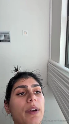 Mia Khalifa lights up a blunt, shaking all over in black thong before the shower