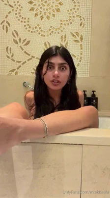 Mia Khalifa works a black vibrator in the tub, then rinses off looking like trouble
