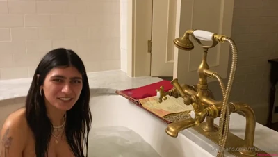 In a bubble-filled marble tub, Mia Khalifa soaks and reads