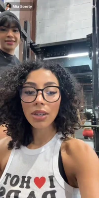 In a white tank and red shorts, Miasorety grinds her ass through every rep, panting hard
