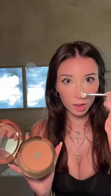Doing her makeup in a black top, Mikaelatesta gets all glammed up