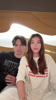 In a loose white tee, Mikaela Testa sprawls out and chats with her man