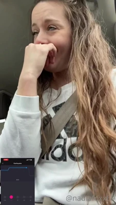 Nadia Foxx giggles in the passenger seat while the quake app shakes