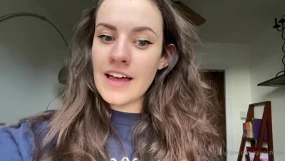 Sitting in a blue sweatshirt, Quinn Finite stares back with wide green eyes