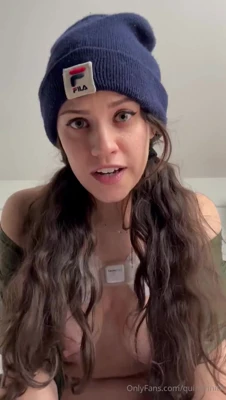 Peeling off her green jacket, Quinn Finite bares her tits and pinches her nipples