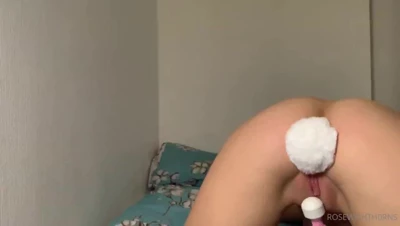 Grinding her clit against a pink rabbit vibrator, Rose lets the fluffy bunny tail plug bounce