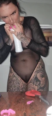 Muddy dropping to her knees in a sheer bodysuit, lapping a pink stroker like it owes her
