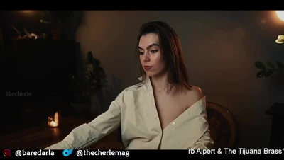 Thecheriemag strips out of her cream shirt and bares her tits for the candlelit room