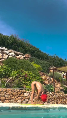 Golden afternoon sun on the pool edge, Thecheriemag strips to a tiny bikini and shows off her tits