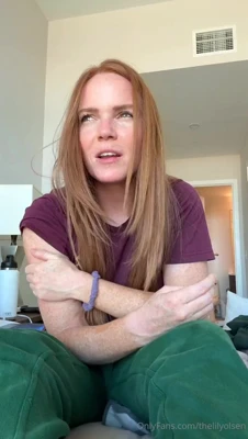 Thelilyolsen cross-legged on the bed in a maroon tee and green sweatpants, stirring up trouble